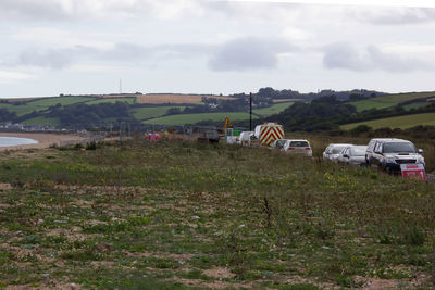 Houses on field against sky