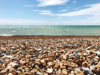 Pebbles on beach against sky