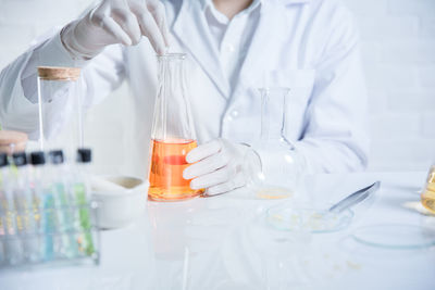 Midsection of scientist working in laboratory