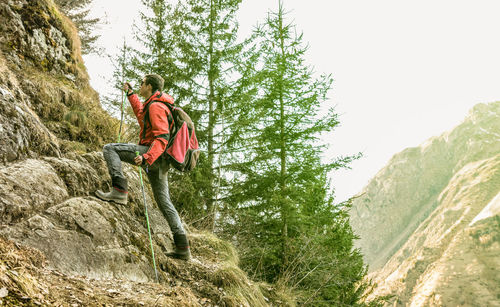 Side view of male hiker hiking on mountain