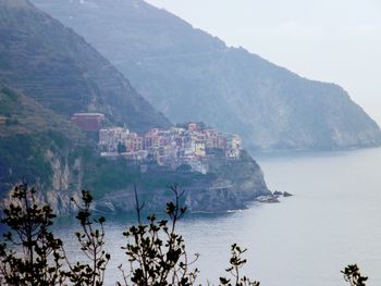 Scenic view of sea and mountains against sky