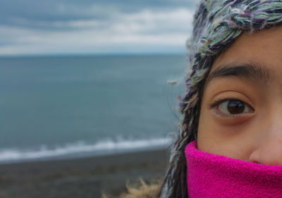Close-up portrait of girl against sea
