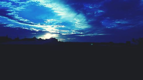 Low angle view of silhouette trees against sky at night