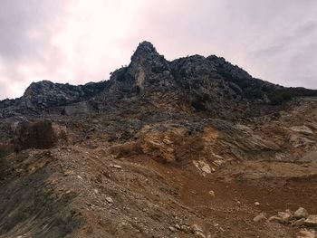 Rock formations on landscape against sky