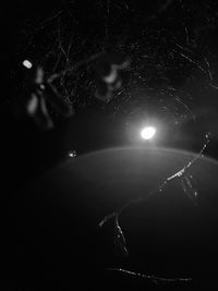 Close-up of illuminated lights against sky at night