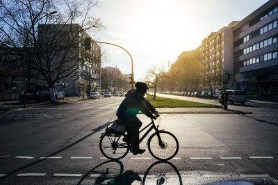 Man riding bicycle on city street