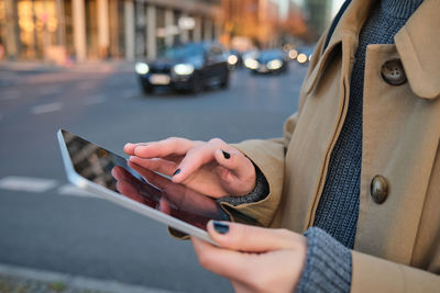 Midsection of woman using mobile phone