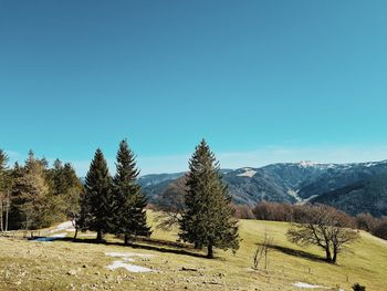 Scenic view of mountains against clear blue sky