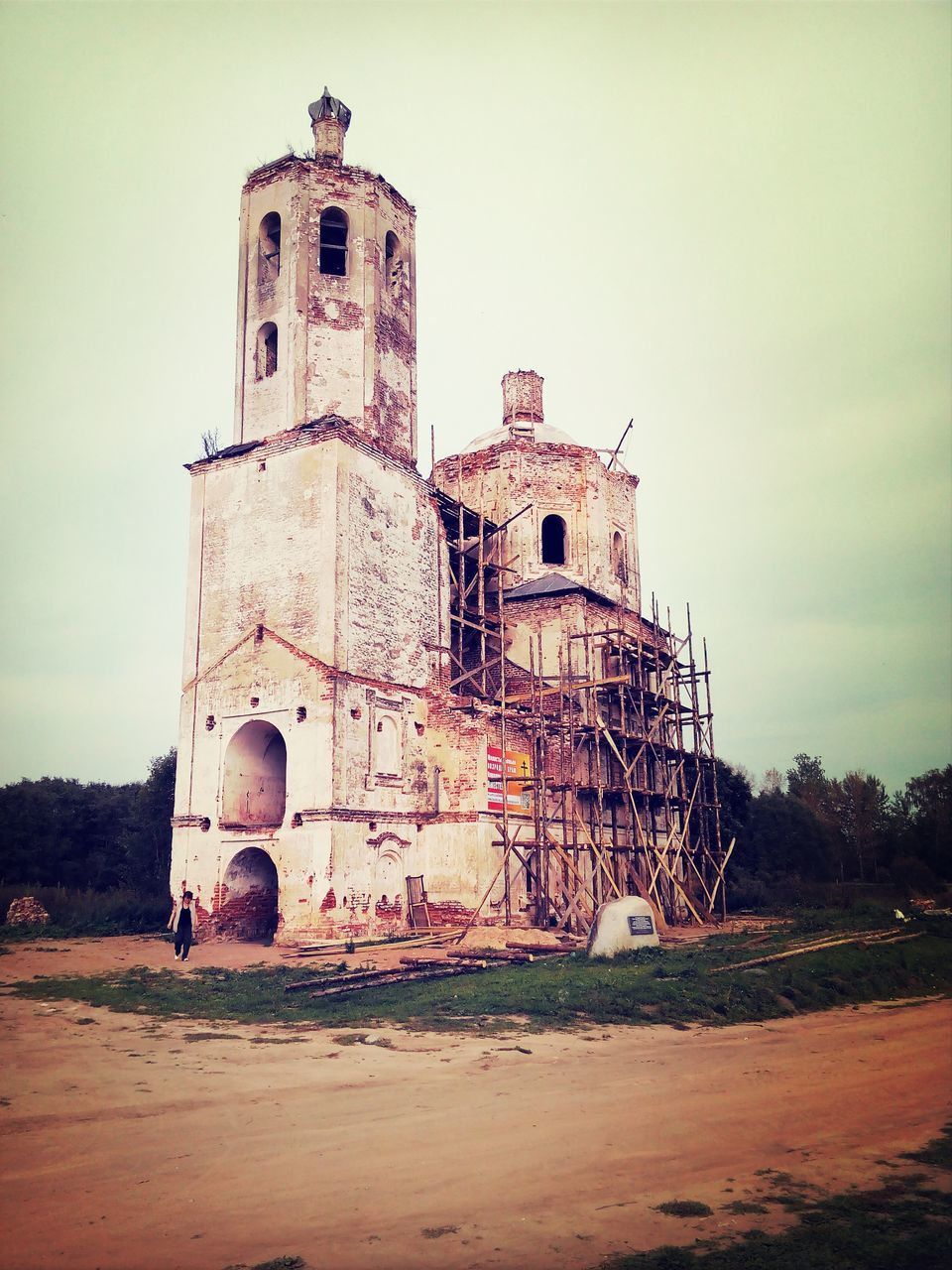 architecture, building exterior, built structure, sky, sand, history, beach, old, incidental people, abandoned, outdoors, travel destinations, damaged, day, the past, tower, travel, famous place, obsolete, low angle view