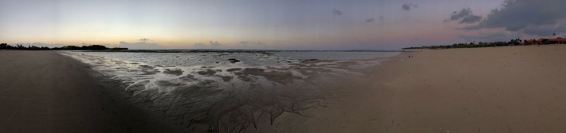 Panoramic view of beach against sky during sunset