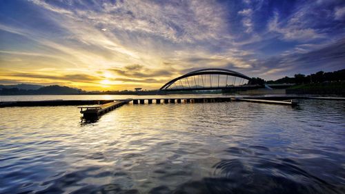 Scenic view of bridge against sky during sunset