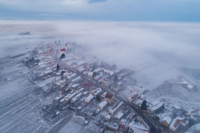 Aerial view of houses during foggy weather