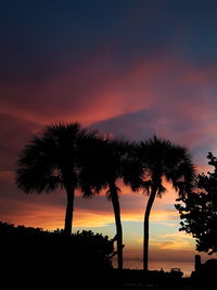 Silhouette trees against sky during sunset