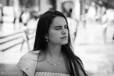 Close-up of thoughtful beautiful woman in city