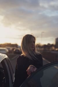 Side view of young woman in car