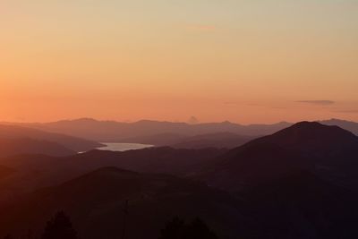 Scenic view of silhouette mountains against sky during sunset