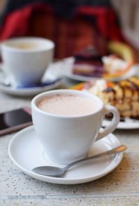 Close-up of coffee cup on table