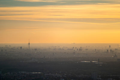 High angle view of buildings in city during sunset