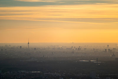 High angle view of buildings in city during sunset