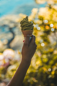 Close-up of hand holding ice cream cone