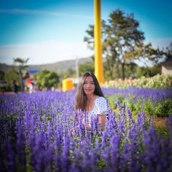 Smiling young woman amidst lavender