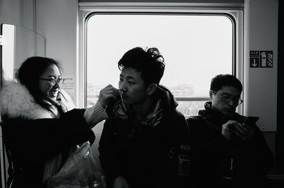 Portrait of young man looking through smart phone