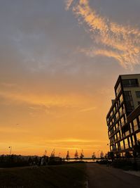 Silhouette buildings against sky during sunset