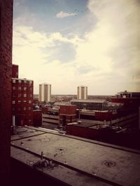 Buildings against cloudy sky