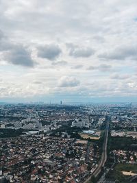 Aerial view of paris cityscape against sky and white clouds with copy space 