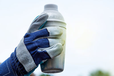 Close-up of human hand holding bottle