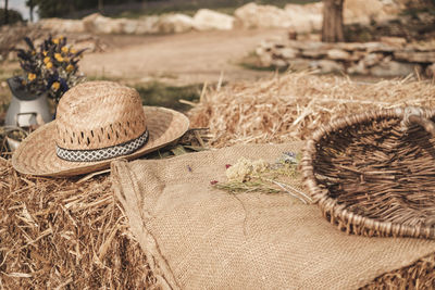 Close-up of hat on wicker basket on field