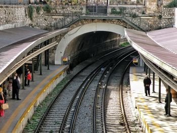 People walking on railroad station platform