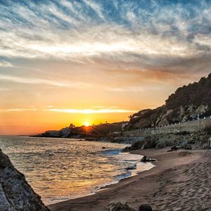 Scenic view of beach against sky during sunset