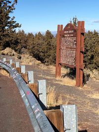 View of text on landscape against clear sky