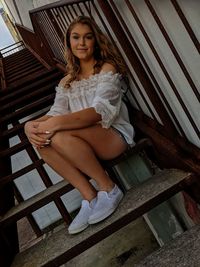 Portrait of woman sitting on staircase