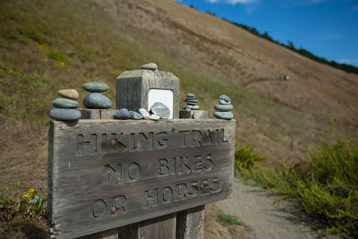 Hiking trail sign on wooden sign board at mountain