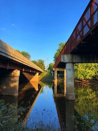 Arch bridge over river against clear sky