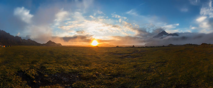 Scenic view of field against sky during sunset