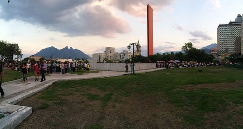 People in park against cloudy sky