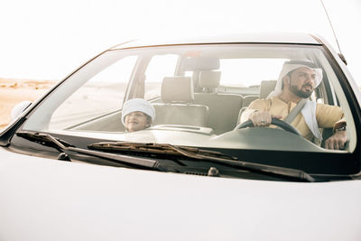 Portrait of man sitting in car