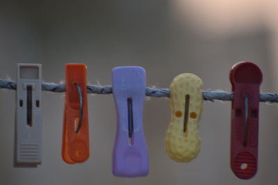 Close-up of clothespins hanging on clothesline