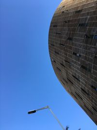 Low angle view of modern building against blue sky