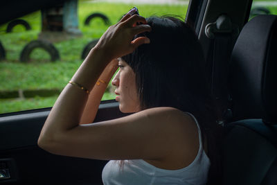 Portrait of woman sitting in car