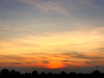 Low angle view of silhouette trees against sky during sunset