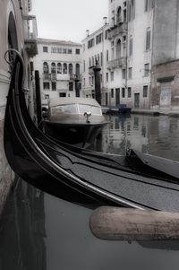 Boats moored on canal in city