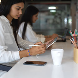 Side view of businesswoman working in office