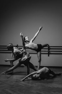 Black and white image of a group of modern little ballerinas standing in a modern dance pose.