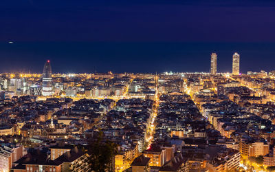 High angle view of city lit up at night