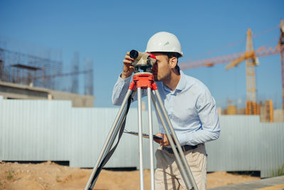 Rear view of man working at construction site