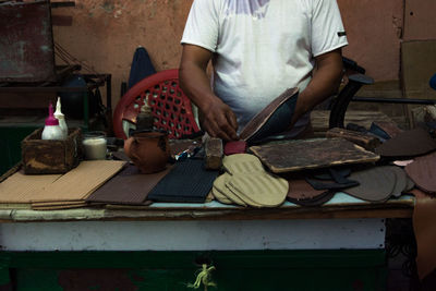 Midsection of man holding food on table